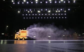 TOPSHOT - This photo taken on May 12, 2020 shows a staff member spraying disinfectant at a theatre as it prepares to reopen in Yantai in China's eastern Shandong province. - China's top decision-making body has given the green light for cinemas, entertainment venues and sports facilities nationwide to reopen after several months of closures. (Photo by STR / AFP) / China OUT (Photo by STR/AFP via Getty Images)