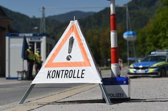 German police officers wearing a protective mask work at the border crossing between Austria and Germany, near the German village of Oberaudorf as Germany enforces border controls with five countries amid the novel coronavirus COVID-19 pandemic on May 7, 2020. - Germany introduced border controls with Austria, Denmark, France, Luxembourg and Switzerland in a bid to stem the coronavirus outbreak. Only those with a valid reason for travel, like cross-border commuters and delivery drivers, are allowed through, officials said. (Photo by Christof STACHE / AFP) (Photo by CHRISTOF STACHE/AFP via Getty Images)