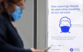 A sign tells commuters that they need to wear PPE (personal protective equipment) of a face covering, or mask, and observe social distancing as a precautionary measure against COVID-19, at Westminster underground station in central London on May 13, 2020, as people start to return to work after COVID-19 lockdown restrictions were eased. - Britain's economy shrank two percent in the first three months of the year, rocked by the fallout from the coronavirus pandemic, official data showed Wednesday, with analysts predicting even worse to come. Prime Minister Boris Johnson began this week to relax some of lockdown measures in order to help the economy, despite the rising death toll, but he has also stressed that great caution is needed. (Photo by DANIEL LEAL-OLIVAS / AFP) (Photo by DANIEL LEAL-OLIVAS/AFP via Getty Images)