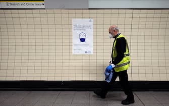 A sign tells commuters that they need to wear PPE (personal protective equipment) of a face covering, or mask as a precautionary measure against COVID-19 as they travel in the morning rush hour at Euston underground station in central London on May 13, 2020, as people start to return to work after COVID-19 lockdown restrictions were eased. - Britain's economy shrank two percent in the first three months of the year, rocked by the fallout from the coronavirus pandemic, official data showed Wednesday, with analysts predicting even worse to come. Prime Minister Boris Johnson began this week to relax some of lockdown measures in order to help the economy, despite the rising death toll, but he has also stressed that great caution is needed. (Photo by Isabel INFANTES / AFP) (Photo by ISABEL INFANTES/AFP via Getty Images)