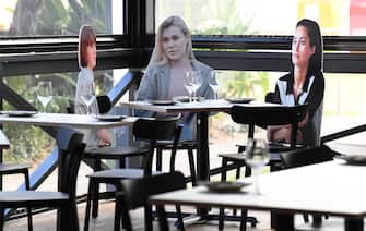 SYDNEY, AUSTRALIA - MAY 14: Cardboard cutouts of human beings sitting at tables inside the Five Dock Dining restaurant on May 14, 2020 in Sydney, Australia. Restaurants and cafes in New South Wales are preparing to reopen with social distancing measures in place as the state government relaxes COVID-19 restrictions.  From Friday 15 May cafes, restaurants and hotel dining areas are allowed to reopen but can only seat 10 patrons at a time and for at least four square metres of space per person. To make patrons feel more comfortable and like they are having a regular dining experience, Five Dock Dining owner Frank Angeletta will use cardboard customers to fill the empty space in his restaurant along with having taped background noise simulating guest "chatter" playing for ambience. (Photo by James D. Morgan/Getty Images)
