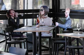SYDNEY, AUSTRALIA - MAY 14: Cardboard cutouts of human beings sitting at tables inside the Five Dock Dining restaurant on May 14, 2020 in Sydney, Australia. Restaurants and cafes in New South Wales are preparing to reopen with social distancing measures in place as the state government relaxes COVID-19 restrictions.  From Friday 15 May cafes, restaurants and hotel dining areas are allowed to reopen but can only seat 10 patrons at a time and for at least four square metres of space per person. To make patrons feel more comfortable and like they are having a regular dining experience, Five Dock Dining owner Frank Angeletta will use cardboard customers to fill the empty space in his restaurant along with having taped background noise simulating guest "chatter" playing for ambience. (Photo by James D. Morgan/Getty Images)