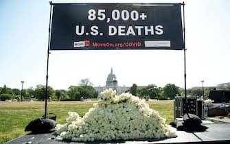 MoveOn.org stages a protest against the handling of the COVID-19 coronavirus pandemic by US President Donald Trump with signs and white roses to remember the people who died from the disease, near the US Capitol in Washington, DC, May 13, 2020. (Photo by SAUL LOEB / AFP) (Photo by SAUL LOEB/AFP via Getty Images)