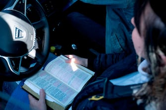 A churchgoer attends a sermon in a car at the Open Church's drive-in service in Copenhagen, Denmark, on the Palm Sunday, on April 5, 2020 amid the novel coronavirus pandemic. - The drive-in service is open to all and is an unconventional attempt to give people an opportunity to attend the mass during the corona crisis. (Photo by Claus Bech / Ritzau Scanpix / AFP) / Denmark OUT (Photo by CLAUS BECH/Ritzau Scanpix/AFP via Getty Images)