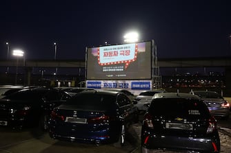 SEOUL, SOUTH KOREA - MARCH 23: People watch a movie at a drive-in theater as South Koreans take measures to protect themselves against the spread of coronavirus (COVID-19) on March 23, 2020 in the Seongdong district of Seoul, South Korea. South Korea has called for expanded public participation in social distancing for the next two weeks, as the country witnesses a wave of community spread and imported infections leading to a resurgence in new cases of COVID-19. According to the Korea Center for Disease Control and Prevention on Monday, 64 new cases were reported. The total number of infections in the nation tallies at 8,961.  (Photo by Chung Sung-Jun/Getty Images)