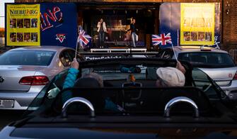 OBERHAUSEN, GERMANY - APRIL 21: The Theater an der Niebuhrg theatre group performs musical hits at a makeshift stage on a truck for a drive-in audience during the coronavirus crisis on April 21, 2020 in Oberhausen, Germany. The drive-in theatre is a means for the group to continue performing and selling tickets while their regular venue remains closed as part of measures aimed at slowing the spread of the novel coronavirus. Across Germany theatres, museums, cinemas, symphonies, opera halls, ballets and other cultural institutions are struggling to make it through the coronavirus lockdown. (Photo by Lars Baron/Getty Images)