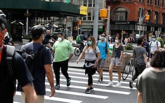 1225300810 NEW YORK, NEW YORK - MAY 16: People wearing protective masks are seen as some restrictions begin to lift during the coronavirus on May 16 2020 in New York City. COVID-19 has spread to most countries around the world, claiming over 312,000 lives and infecting over 4.7 million people. (Photo by John Lamparski/Getty Images)