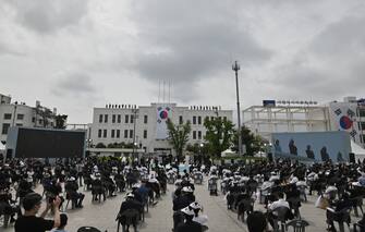 South Korean performers sing a song during a ceremony marking the 40th anniversary of the pro-democracy Gwangju Uprising at May 18 Democracy Square in Gwangju on May 18, 2020. (Photo by JUNG YEON-JE / POOL / AFP) (Photo by JUNG YEON-JE/POOL/AFP via Getty Images)