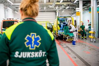 A healthcare worker cleans and disinfects an ambulance after dropping a patient at the Intensive Care Unit (ICU) at Danderyd Hospital near Stockholm on May 13, 2020, during the coronavirus COVID-19 pandemic. (Photo by Jonathan NACKSTRAND / AFP) (Photo by JONATHAN NACKSTRAND/AFP via Getty Images)
