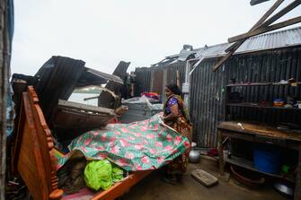 A woman salvages items from her house damaged by cyclone Amphan in Satkhira on May 21, 2020. - The strongest cyclone in decades slammed into Bangladesh and eastern India on May 20, sending water surging inland and leaving a trail of destruction as the death toll rose to at least nine. (Photo by Munir UZ ZAMAN / AFP) (Photo by MUNIR UZ ZAMAN/AFP via Getty Images)