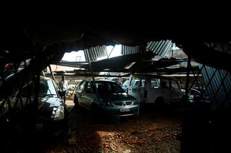 A man checks cars in a garage damaged by cyclone Amphan in Satkhira on May 21, 2020. - The strongest cyclone in decades slammed into Bangladesh and eastern India on May 20, sending water surging inland and leaving a trail of destruction as the death toll rose to at least nine. (Photo by Munir UZ ZAMAN / AFP) (Photo by MUNIR UZ ZAMAN/AFP via Getty Images)