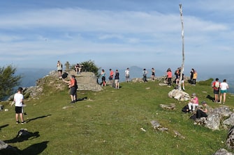 Mountain hikers take a break at the top of the Mondarrain Mount near Itxassou, southwestern France, on May 21, 2020 as France eases lockdown measures taken to curb the spread of the COVID-19 (the novel coronavirus). (Photo by GAIZKA IROZ / AFP)