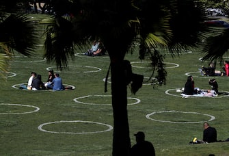 SAN FRANCISCO, CALIFORNIA - MAY 20: People sit in social distancing circles at Dolores Park on May 20, 2020 in San Francisco, California. The move follows similar moves by other parks in cities around the world in an effort to get back to some semblance of normalcy.  (Photo by Justin Sullivan/Getty Images)