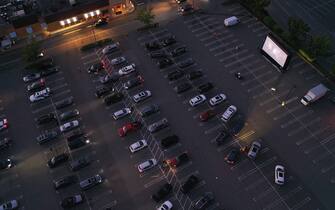 HICKSVILLE, NEW YORK - MAY 21: In an aerial view from a drone, attendees watch the movie "The Goonies" at a pop-up drive-in theatre built in the parking lot at the Broadway Commons on May 21, 2020 in Hicksville, New York. The function was organized as a partnership between Broadway Commons and Ishevents as organizations look to keep people entertained while maintaining social distance. (Photo by Bruce Bennett/Getty Images)