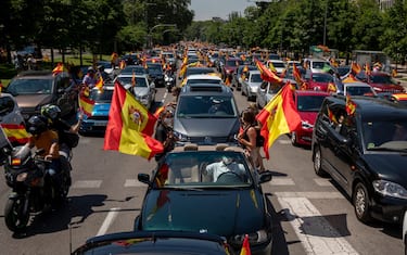 MADRID, SPAIN - MAY 23: People holding Spanish flags take part on an in-vehicle protest against the Spanish government on May 23, 2020 in Madrid, Spain. Far right wing VOX party has called for in-vehicle protests across Spain against the Spanish government's handling of the Covid-19 pandemic. Spain has imposed some of the tightest restrictions across the world to contain the spread of the virus, but measures are now easing. Most of the Spanish population supports the lockdown according to a survey. (Photo by Pablo Blazquez Dominguez/Getty Images)