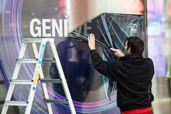 GENEVA, SWITZERLAND - FEBRUARY 28: Worker strips down the banners due the cancellation of the Geneva Auto Show on February 28, 2020 in Geneva, Switzerland. Swiss authorities announced today that all upcoming events with more than 1,000 attendees will be cancelled in an attempt to prevent further spread of the coronavirus. Hundreds of coronavirus cases have been confirmed in nearby northern Italy and smaller numbers of cases are being confirmed daily across western Europe. (Photo by Robert Hradil/Getty Images)