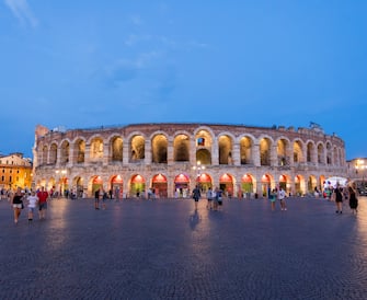 1024061626 VERONA, ITALY - AUGUST 03: The Verona Arena illuminated at night on August 03, 2018 in Verona, Italy. The Verona Arena is a Roman amphitheatre in Piazza Bra in Verona. It is still in use today and is internationally famous for the large-scale opera performances given there. Verona is a city on the Adige river in Veneto. It is one of the main tourist destinations in northern Italy, owing to its artistic heritage and several annual fairs, shows, and operas, such as the lyrical season in the Arena, the ancient amphitheater built by the Romans.The city has been declared a World Heritage Site by UNESCO because of its urban structure and architecture. (Photo by Athanasios Gioumpasis/Getty Images)