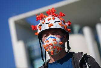 BERLIN, GERMANY - MAY 27: An activist dressed as the coronavirus attends a protest outside the Chancellery against the recent Lufthansa bailout during the coronavirus crisis on May 27, 2020 in Berlin, Germany. The German government announced Monday it will prop up German airline Lufthansa with a EUR 9 billion package that includes a 20% government stake in the company. The activists were protesting both against the fiscal and the environmental implications of the bailout.  (Photo by Sean Gallup/Getty Images)