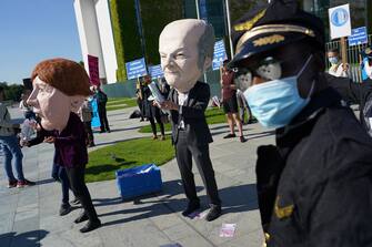 BERLIN, GERMANY - MAY 27: Activists dressed as German Chancellor Angela Merkel and Finance Minister Olaf Scholz take part in a protest outside the Chancellery against the recent Lufthansa bailout on May 27, 2020 in Berlin, Germany. The German government announced Monday it will prop up German airline Lufthansa with a EUR 9 billion package that includes a 20% government stake in the company. The activists were protesting both against the fiscal and the environmental implications of the bailout.  (Photo by Sean Gallup/Getty Images)