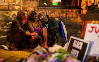 Shawanda Hill (C), the girlfriend of George Floyd reacts near the spot where he died while in custody of the Minneapolis Police, on May 26, 2020 in Minneapolis, Minnesota. - A video of a handcuffed black man dying while a Minneapolis officer knelt on his neck for more than five minutes sparked a fresh furor in the US over police treatment of African Americans Tuesday. Minneapolis Mayor Jacob Frey fired four police officers following the death in custody of George Floyd on Monday as the suspect was pressed shirtless onto a Minneapolis street, one officer's knee on his neck. (Photo by kerem yucel / AFP) (Photo by KEREM YUCEL/AFP via Getty Images)