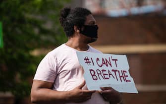 MINNEAPOLIS, MN - MAY 26: A man holds a sign stating "I Can't Breathe" during a protest in response to the killing of George Floyd outside the Cup Foods on May 26, 2020 in Minneapolis, Minnesota. Four Minneapolis police officers have been fired after a video taken by a bystander was posted on social media showing Floyd's neck being pinned to the ground by an officer as he repeatedly said, "I can’t breathe". Floyd was later pronounced dead while in police custody after being transported to Hennepin County Medical Center. (Photo by Stephen Maturen/Getty Images)