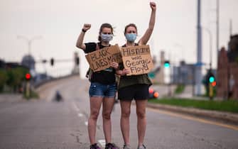 MINNEAPOLIS, MN - MAY 26: Women hold signs decrying the killing of George Floyd during a protest march on May 26, 2020 in Minneapolis, Minnesota. Four Minneapolis police officers have been fired after a video taken by a bystander was posted on social media showing Floyd's neck being pinned to the ground by an officer as he repeatedly said, "I can’t breathe". Floyd was later pronounced dead while in police custody after being transported to Hennepin County Medical Center. (Photo by Stephen Maturen/Getty Images)
