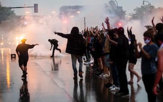 MINNEAPOLIS, MN - MAY 26: Tear gas is fired as protesters clash with police while demonstrating against the death of George Floyd outside the 3rd Precinct Police Precinct on May 26, 2020 in Minneapolis, Minnesota. Four Minneapolis police officers have been fired after a video taken by a bystander was posted on social media showing Floyd's neck being pinned to the ground by an officer as he repeatedly said, "I can’t breathe". Floyd was later pronounced dead while in police custody after being transported to Hennepin County Medical Center. (Photo by Stephen Maturen/Getty Images)
