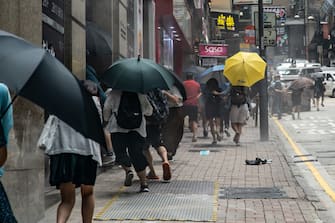 HONG KONG, CHINA - MAY 27: Pedestrians run as riot police fire a pepper spray projectile at them during a Lunch with You rally in Central district on May 27, 2020 in Hong Kong, China. Chinese Premier Li Keqiang said on Friday during the National People's Congress that Beijing would establish a sound legal system and enforcement mechanism for safeguarding national security in Hong Kong.(Photo by Anthony Kwan/Getty Images)