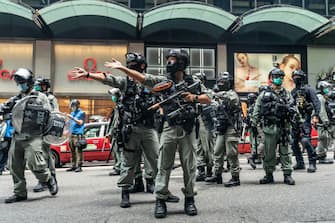HONG KONG, CHINA - MAY 27: Riot police secure an area during a Lunch with You rally in Central district on May 27, 2020 in Hong Kong, China. Chinese Premier Li Keqiang said on Friday during the National People's Congress that Beijing would establish a sound legal system and enforcement mechanism for safeguarding national security in Hong Kong.(Photo by Anthony Kwan/Getty Images)