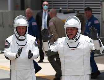 CAPE CANAVERAL, FLORIDA - MAY 27: NASA astronauts Bob Behnken (R) and Doug Hurley (L) walk out of the Operations and Checkout Building on their way to the SpaceX Falcon 9 rocket with the Crew Dragon spacecraft on launch pad 39A at the Kennedy Space Center on May 27, 2020 in Cape Canaveral, Florida. The inaugural flight will be the first manned mission since the end of the Space Shuttle program in 2011 to be launched into space from the United States.  (Photo by Joe Raedle/Getty Images)