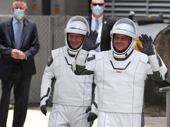 1227400346 CAPE CANAVERAL, FLORIDA - MAY 27: NASA astronauts Bob Behnken (R) and Doug Hurley (L) walk out of the Operations and Checkout Building on their way to the SpaceX Falcon 9 rocket with the Crew Dragon spacecraft on launch pad 39A at the Kennedy Space Center on May 27, 2020 in Cape Canaveral, Florida. The inaugural flight will be the first manned mission since the end of the Space Shuttle program in 2011 to be launched into space from the United States. (Photo by Joe Raedle/Getty Images)