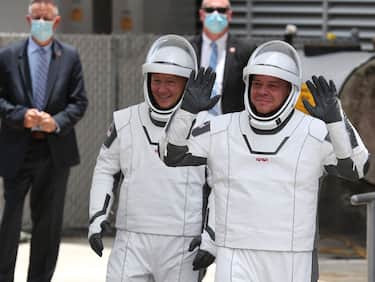 CAPE CANAVERAL, FLORIDA - MAY 27: NASA astronauts Bob Behnken (R) and Doug Hurley (L) walk out of the Operations and Checkout Building on their way to the SpaceX Falcon 9 rocket with the Crew Dragon spacecraft on launch pad 39A at the Kennedy Space Center on May 27, 2020 in Cape Canaveral, Florida. The inaugural flight will be the first manned mission since the end of the Space Shuttle program in 2011 to be launched into space from the United States.  (Photo by Joe Raedle/Getty Images)