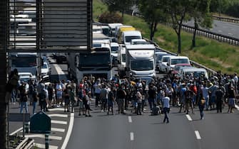 Nissan employees cut off the B-10 highway in Barcelona, as they protest against the closure of the Japanese cars manufacturer's plant in Barcelona on May 28, 2020. - Japanese carmaker Nissan has decided to shut its factory in Barcelona where 3,000 people are employed, the Spanish government said today. (Photo by LLUIS GENE / AFP) (Photo by LLUIS GENE/AFP via Getty Images)