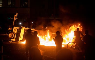 MINNEAPOLIS, MN - MAY 28: A surveillance camera burns in the parking lot of the Third Police Precinct on May 28, 2020 in Minneapolis, Minnesota. As unrest continues after the death of George Floyd police abandoned the precinct building, allowing protesters to set fire to it. (Photo by Stephen Maturen/Getty Images)