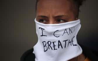 MINNEAPOLIS, MINNESOTA - MAY 29: A person wears a mask that reads "I CAN'T BREATHE" as demonstrators continue to protest the death of George Floyd following a night of rioting on May 29, 2020 in Minneapolis, Minnesota. Earlier today, former Minneapolis police officer Derek Chauvin was taken into custody for Floyd's death. Chauvin has been accused of kneeling on Floyd's neck as Floyd pleaded with him about not being able to breathe. Floyd was pronounced dead a short while later. Chauvin and 3 other officers, who were involved in the arrest, were fired from the police depart after a video of the arrest was circulated.   Scott Olson/Getty Images/AFP
== FOR NEWSPAPERS, INTERNET, TELCOS & TELEVISION USE ONLY ==