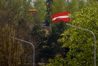 The Latvian and Lithuanian flags are seen at the Latvia-Lithuania border crossing at Skaistkalne, Latvia on May 14, 2020, ahead of border reopening. - After two months of coronavirus-related restrictions, the Baltic States agreed to lift travel restrictions and ensure free movement of their residents by land, sea and air: the so-called 'Baltic Bubble' from May 15, 2020. (Photo by Gints Ivuskans / AFP) (Photo by GINTS IVUSKANS/AFP via Getty Images)