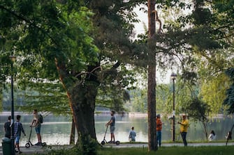 Romanians enjoy a day in a park, that has just reopened, in Bucharest's city center on the first day that the lockdown imposed to stop the spread of the new coronavirus is lifted, on May 15, 2020. (Photo by Andrei PUNGOVSCHI / AFP) (Photo by ANDREI PUNGOVSCHI/AFP via Getty Images)