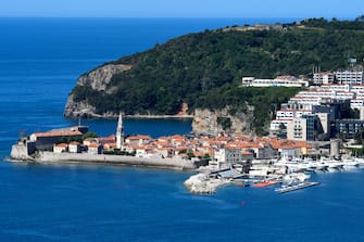 This picture taken on May 13, 2020, shows a general view of the town of Budva, on the Adriatic coast of Montenegro. - Less than two months after detecting its first infection, Montenegro is the first country in Europe to declare itself coronavirus-free, a success story the tiny country hopes will lure tourists to its dazzling Adriatic coast this summer. Tourism operators have already seized the opportunity to brand Montenegro as "Europe's First COVID-19 Free Country" in videos promoting its stunning natural beauty, with beaches snaking along the south and rugged mountains in the north. (Photo by SAVO PRELEVIC / AFP) (Photo by SAVO PRELEVIC/AFP via Getty Images)