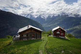 A picture taken on May 14, 2020 shows two chalet at the Alpine village of Gspon. (Photo by Fabrice COFFRINI / AFP) (Photo by FABRICE COFFRINI/AFP via Getty Images)