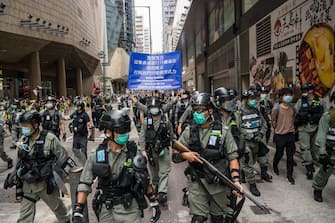 HONG KONG, CHINA - MAY 27: Riot police stand guard during a protest against a planned national security law at Admiralty district on May 27, 2020 in Hong Kong, China. Chinese Premier Li Keqiang said on Friday during the National People's Congress that Beijing would establish a sound legal system and enforcement mechanism for safeguarding national security in Hong Kong.(Photo by Billy H.C. Kwok/Getty Images)