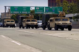 California National Guard armed vehicules are seen on the freeway as they patrol after demonstrators protested the death of George Floyd in Los Angeles, California on May 31, 2020. - Thousands of National Guard troops patrolled major US cities  after five consecutive nights of protests over racism and police brutality that boiled over into arson and looting, sending shock waves through the country. The death Monday of an unarmed black man, George Floyd, at the hands of police in Minneapolis ignited this latest wave of outrage in the US over law enforcement's repeated use of lethal force against African Americans -- this one like others before captured on cellphone video. (Photo by Agustin PAULLIER / AFP) (Photo by AGUSTIN PAULLIER/AFP via Getty Images)