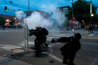 Demonstrators throw rocks at police officers during a protest in Denver, Colorado on May 31, 2020, while protesting the death of George Floyd, an unarmed black man who died while while being arrested and pinned to the ground by the knee of a Minneapolis police officer. - Thousands of National Guard troops patrolled major US cities  after five consecutive nights of protests over racism and police brutality that boiled over into arson and looting, sending shock waves through the country. The death Monday of an unarmed black man, George Floyd, at the hands of police in Minneapolis ignited this latest wave of outrage in the US over law enforcement's repeated use of lethal force against African Americans -- this one like others before captured on cellphone video. (Photo by Jason Connolly / AFP) (Photo by JASON CONNOLLY/AFP via Getty Images)