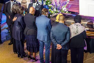 People show their respects to the remains of George Floyd awaiting a memorial service in his honor on June 4, 2020, at North Central University's Frank J. Lindquist Sanctuary in Minneapolis, Minnesota. - On May 25, 2020, Floyd, a 46-year-old black man suspected of passing a counterfeit $20 bill, died in Minneapolis after Derek Chauvin, a white police officer, pressed his knee to Floyd's neck for almost nine minutes. (Photo by kerem yucel / AFP) (Photo by KEREM YUCEL/AFP via Getty Images)