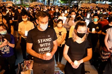 People hold candles in front of the Chiang Kai-shek Memorial Hall, also known as Free Square, to mark the 31st anniversary of the 1989 Tiananmen Square crackdown in Taipei in June 4, 2020. (Photo by Sam Yeh / AFP) (Photo by SAM YEH/AFP via Getty Images)