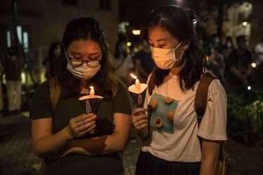 People burn candles during a mass outside a church in Hong Kong on June 4, 2020, to mark the 31st anniversary of the 1989 Tiananmen crackdown in Beijing. (Photo by DALE DE LA REY / AFP) (Photo by DALE DE LA REY/AFP via Getty Images)