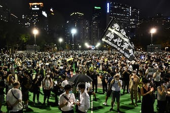 Activists hold a candlelit remembrance outside Victoria Park in Hong Kong on June 4, 2020, after an annual vigil that traditionally takes place in the park to mark the 1989 Tiananmen Square crackdown was banned on public health grounds because of the COVID-19 coronavirus pandemic. (Photo by Anthony WALLACE / AFP) (Photo by ANTHONY WALLACE/AFP via Getty Images)