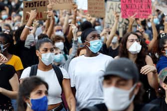 1242081693 PARIS, FRANCE - JUNE 02: Protesters gather for a demonstration after French medical experts exonerated the gendarme involved in the arrest of Adama Traore, a young black man who died in police custody in 2016, outside the "Tribunal de Paris" courthouse on June 02, 2020 in Paris, France. (Photo by Pierre Suu/Getty Images)