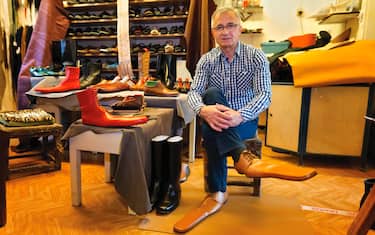 epa08466338 Romanian shoemaker Grigore Lup poses while wearing a pair of men's social-distancing shoes he invented during the Coronavirus pandemic, at his workshop, in Cluj Napoca city, 500 kms north-west of Bucharest, Romania, 04 June 2020 (issued 05 June 2020). Lup, 55, invented the social distancing shoes in a bid to save his small business in the midst of the Coronavirus crisis. The shoemaker is manufacturing by hand each pair of social distancing shoes, measuring 75 centimeters, using the best natural leather, hand tools plus his 39 years professional experience. After receiving attention from the local media, he began to receive orders from around the world. Most of his customers are confessing that they want to wear his creations on the street or at special occasions. The master shoemaker, who managed to survive the global financial crisis of 2008 by moving from normal shoes to the production of footwear for dance companies and theaters, turned the disadvantage of the Covid-19 pandemic in his favor, producing social distance shoes for both men and women. He is selling a pair of his special shoes for about 100 euros. EPA/Alexandru Pop To go with the story: 'Number 75 shoes to enforce social distance' by Marcel Gascon/EFE