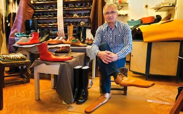 epa08466338 Romanian shoemaker Grigore Lup poses while wearing a pair of men's social-distancing shoes he invented during the Coronavirus pandemic, at his workshop, in Cluj Napoca city, 500 kms north-west of  Bucharest, Romania, 04 June 2020 (issued 05 June 2020). Lup, 55, invented the social distancing shoes in a bid to save his small business in the midst of the Coronavirus crisis. The shoemaker is manufacturing by hand each pair of social distancing shoes, measuring 75 centimeters, using the best natural leather, hand tools plus his 39 years professional experience. After receiving attention from the local media, he began to receive orders from around the world. Most of his customers are confessing that they want to wear his creations on the street or at special occasions. The master shoemaker, who managed to survive the global financial crisis of 2008 by moving from normal shoes to the production of footwear for dance companies and theaters, turned the disadvantage of the Covid-19 pandemic in his favor, producing social distance shoes for both men and women. He is selling a pair of his special shoes for about 100 euros.  EPA/Alexandru Pop To go with the story: 'Number 75 shoes to enforce social distance' by Marcel Gascon/EFE