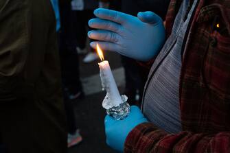 TACOMA, WA - JUNE 03: A person holds a candle during a vigil for Manuel Ellis, a black man whose March death while in Tacoma Police custody was recently found to be a homicide, according to the Pierce County Medical Examiners Office, near the site of his death on June 3, 2020 in Tacoma, Washington. Protests and other events sparked by the death of George Floyd have continued in the Tacoma area after the Medical Examiner found that the cause of death in the Manuel Ellis case was caused by respiratory arrest due to hypoxia due to physical restraint. (Photo by David Ryder/Getty Images)
